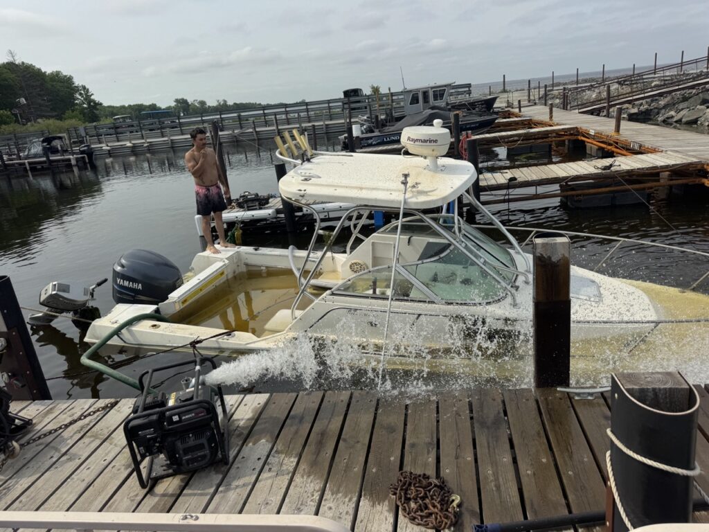 Crew and equipment recovering a 24-foot boat from Lake of the Woods